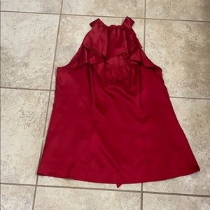 Red sleeveless dressy top.